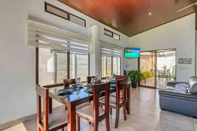 a dining room with a table and chairs and a couch at Casa Maiki Your Private Retreat in Uvita Center in Uvita