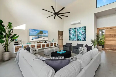 a living room with a white couch and chairs at Casa Ola Aloha in Playa Avellana