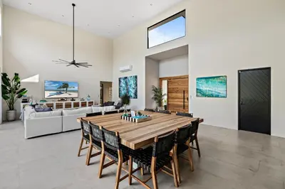 a dining room with a large wooden table and chairs at Casa Ola Aloha in Playa Avellana