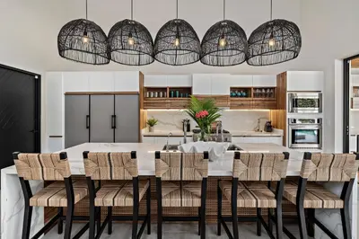 a kitchen and dining room with a white table and chairs at Casa Ola Aloha in Playa Avellana