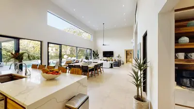 an open kitchen and dining room with a large window at Casa Ola Aloha in Playa Avellana