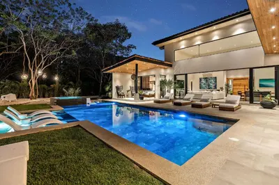 a swimming pool in the backyard of a house at Casa Ola Aloha in Playa Avellana