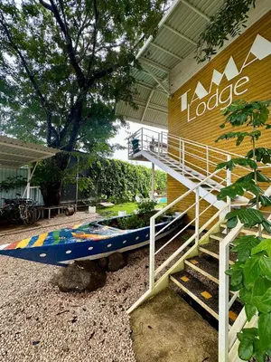 a surfboard sitting outside of a building at Hotel Tama Lodge in Tamarindo