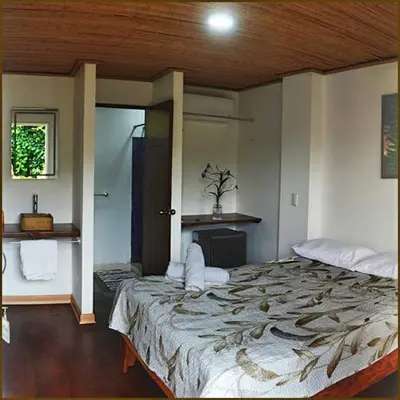 a bedroom with a large bed in a room at Hotel Tama Lodge in Tamarindo
