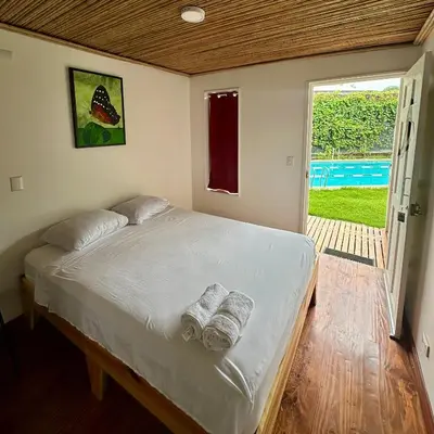 a bedroom with a bed with towels on it at Hotel Tama Lodge in Tamarindo