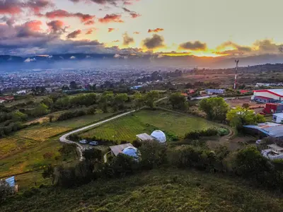 an aerial view of a field with a city at Tocuma Glamping in Cartago