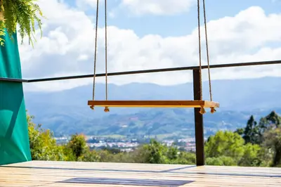a swing with a view of the mountains at Tocuma Glamping in Cartago