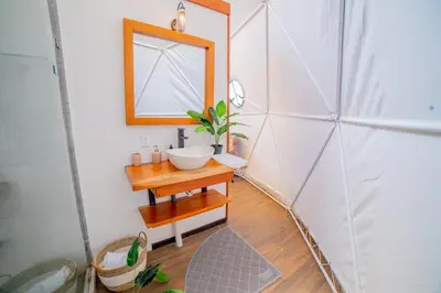 a bathroom with a sink and a mirror at Tocuma Glamping in Cartago