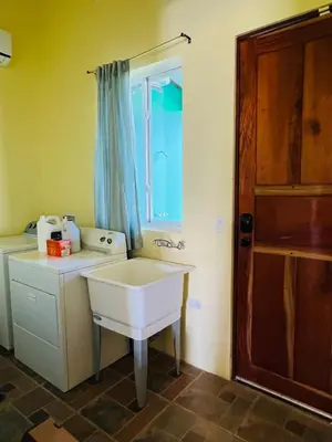 a small bathroom with a sink and a window at Guayabo Animal Rescue & Sanctuary in Hacienda Miravalles