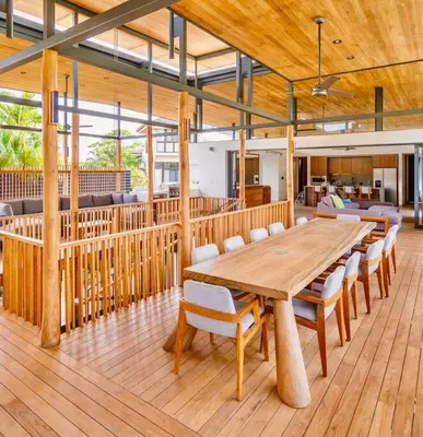 a dining room with a wooden table and chairs at Nimbu West in Tamarindo
