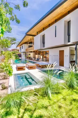 a house with a swimming pool in the yard at Nimbu West in Tamarindo