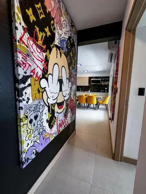 a hallway with a wall covered in graffiti at Luxury Condo at Viva Jaco Residence in Jacó