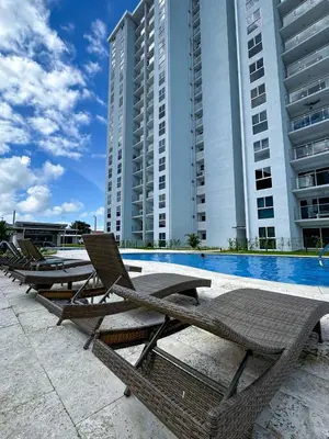 a row of lounge chairs next to a swimming pool at Luxury Condo at Viva Jaco Residence in Jacó