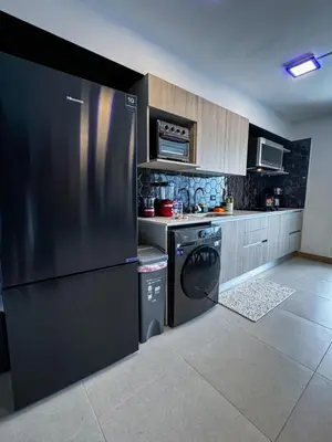 a kitchen with a refrigerator and a dishwasher at Luxury Condo at Viva Jaco Residence in Jacó