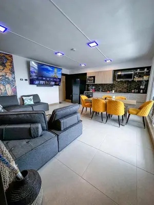 a living room with a couch and a table at Luxury Condo at Viva Jaco Residence in Jacó