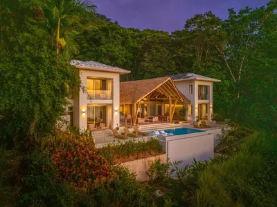 an exterior view of a house with a swimming pool at Casa Frenchie & Villas Vista del Mar - by Pura Villas in Dominicalito
