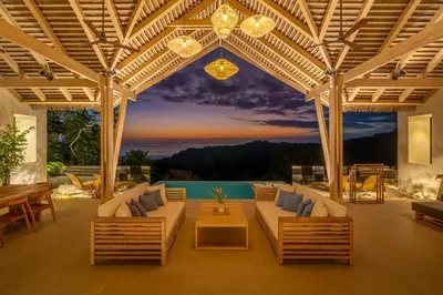 a patio with couches and a table and a table at Casa Frenchie & Villas Vista del Mar - by Pura Villas in Dominicalito