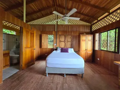 a bedroom with a bed and a ceiling fan at LiS house in San Luis