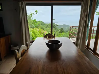a bowl on a wooden table with a large window at LiS house in San Luis