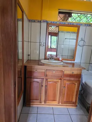 a bathroom with a sink and a mirror and a toilet at LiS house in San Luis