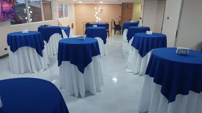 a row of blue and white tables in a room at Hotel Puerto Limón CR in Puerto Limón