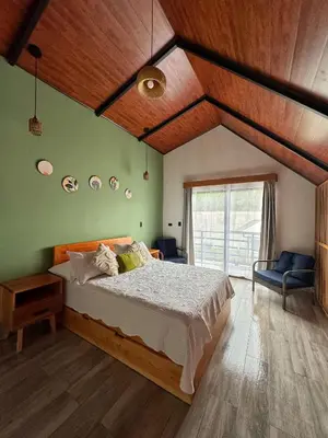 a bedroom with a large bed and a large window at Alma Vida Lofts in Fortuna