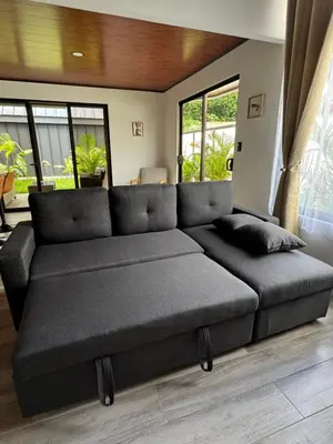 a large couch in a living room with windows at Alma Vida Lofts in Fortuna