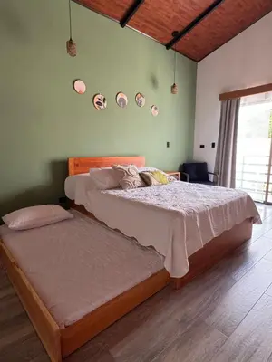 a bedroom with a large bed and some plates on the wall at Alma Vida Lofts in Fortuna