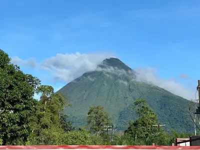 a mountain with clouds on top of it at Alma Vida Lofts in Fortuna