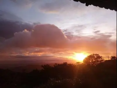 a sunset with the sun setting in the sky at Casa Cabuya - Retro Style with Gulf View in Monteverde in Monteverde Costa Rica