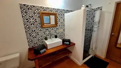 a bathroom with a sink and a mirror at Casa Cabuya - Retro Style with Gulf View in Monteverde in Monteverde Costa Rica