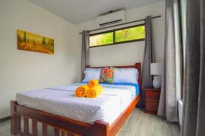 a bedroom with a bed with two pumpkins on it at 3bdr House in Uvita LAPA Ocean View in Uvita