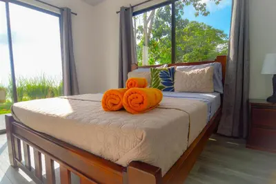 a bedroom with a bed with orange towels on it at 3bdr House in Uvita LAPA Ocean View in Uvita