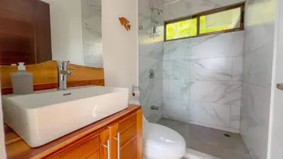 a bathroom with a sink and a toilet at 3bdr House in Uvita LAPA Ocean View in Uvita