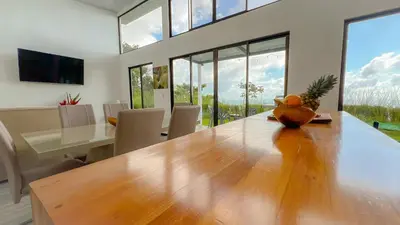 a dining room with a large wooden table and chairs at 3bdr House in Uvita LAPA Ocean View in Uvita