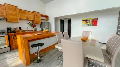 a kitchen and dining room with a table and chairs at 3bdr House in Uvita LAPA Ocean View in Uvita