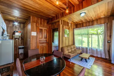 a living room with a table and a couch at Rustic Treehouse Monteverde in Monteverde Costa Rica