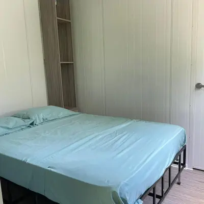 a hospital bed with a blue sheet in a room at Apartamento Estilo Container in Guápiles