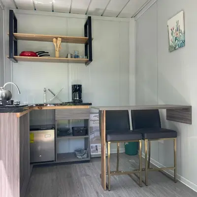 a small kitchen with a table and two chairs at Apartamento Estilo Container in Guápiles