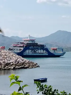 a large cruise ship in a body of water at Cabinas El Jardin in Paquera