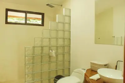 a bathroom with a toilet and a sink at Casa Manzanillo Surf in Manzanillo