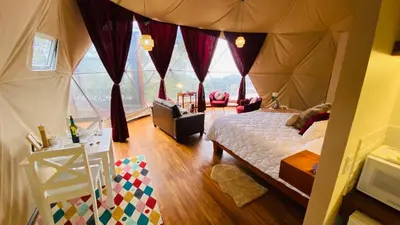 a bedroom with a bed in a tent at FéLIZA Rainforest Domes in Monteverde Costa Rica