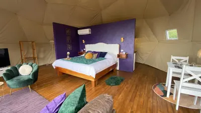 a bedroom with a bed in a tent at FéLIZA Rainforest Domes in Monteverde Costa Rica