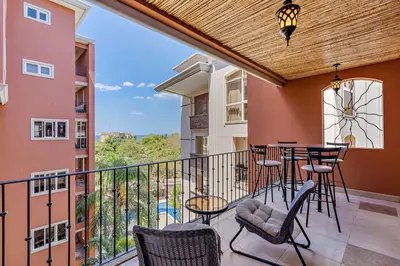 a balcony with chairs and a table with a view at Casa feng shui in Tamarindo