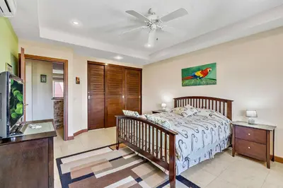 a bedroom with a bed and a ceiling fan at Casa feng shui in Tamarindo