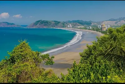 a view of a beach with trees and the ocean at Ciudad del Mar 31 in Jacó
