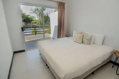 a bedroom with a bed and a large window at Ciudad del Mar 31 in Jacó