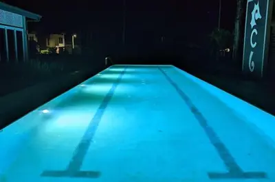 a swimming pool in a dark room with blue lights at Ciudad del Mar 31 in Jacó