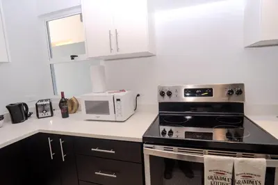 a kitchen with a stove and a microwave at Ciudad del Mar 31 in Jacó