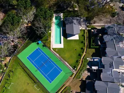 an aerial view of a house with a tennis court at Ciudad del Mar 31 in Jacó